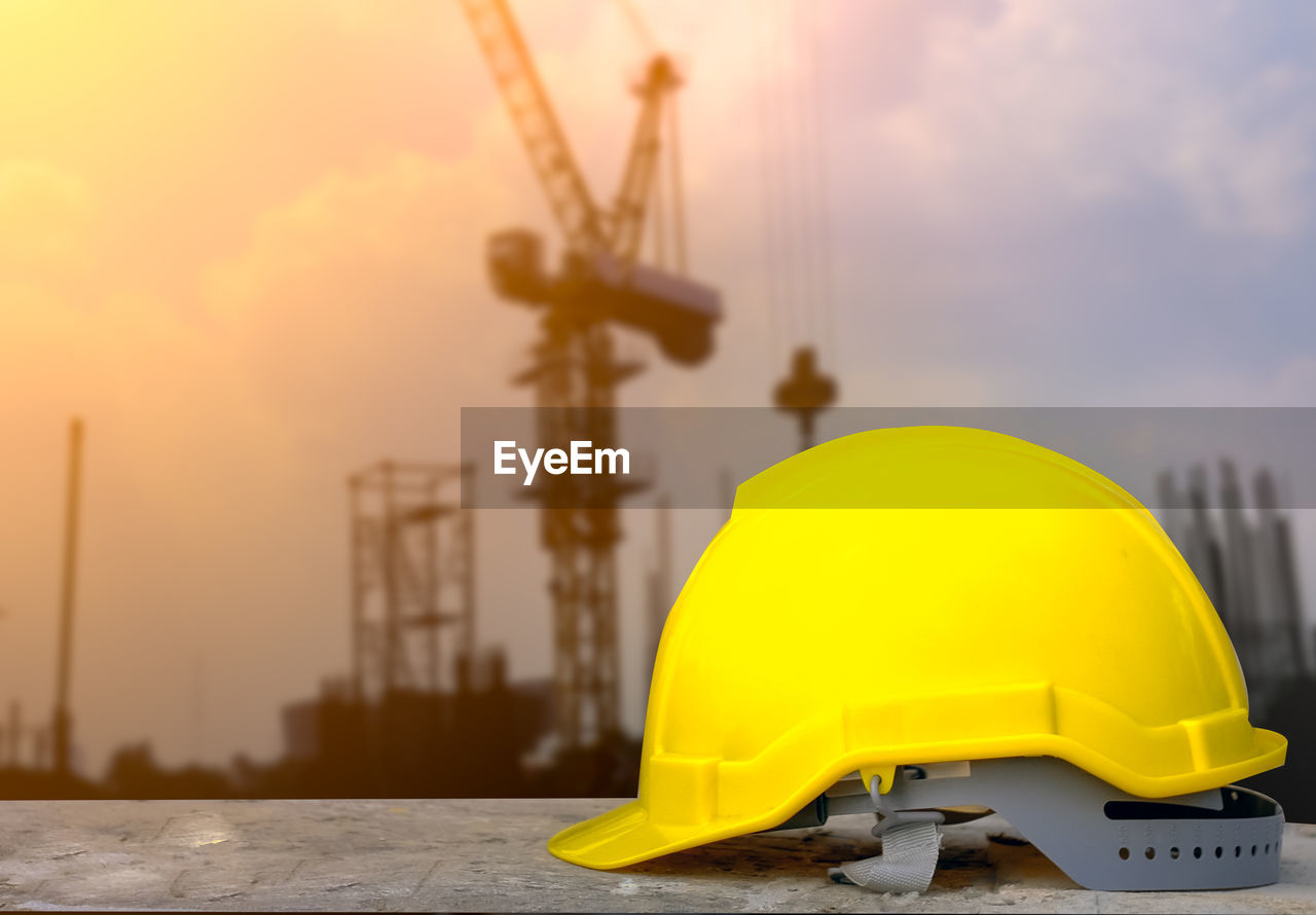 Yellow hat on construction site against sky