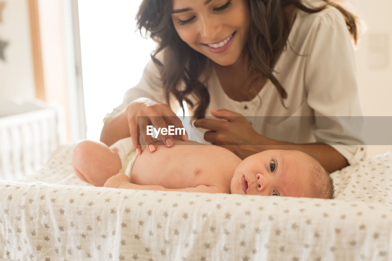 Mother playing with son at home