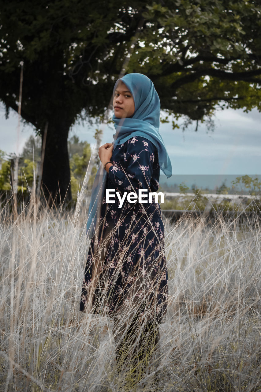 Side view of woman standing on field