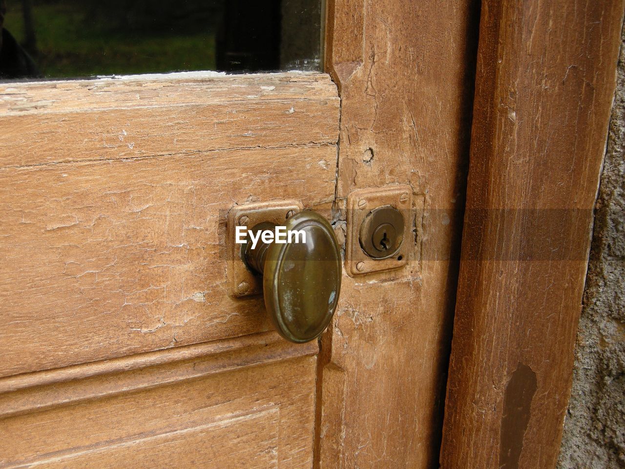 CLOSE-UP OF DOOR HANDLE ON WOODEN TABLE