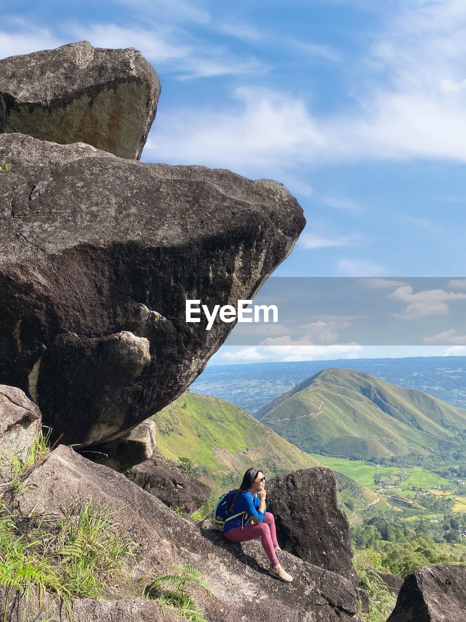 Batu marompa, samosir, indonesia - a woman sits on the rock