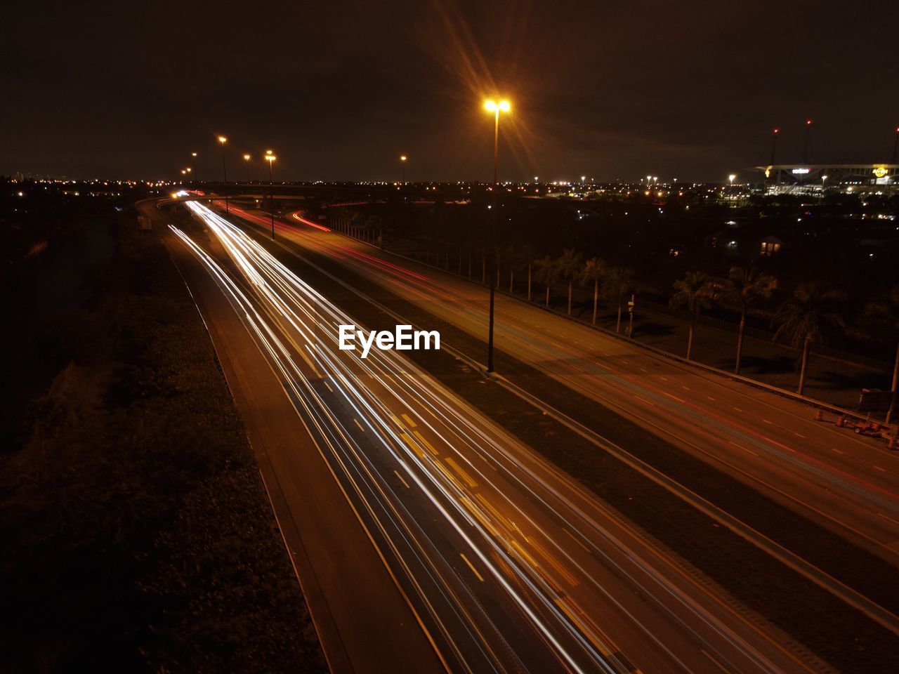 HIGH ANGLE VIEW OF LIGHT TRAILS ON ROAD