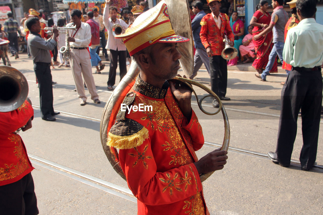 Side view of musician during procession at street