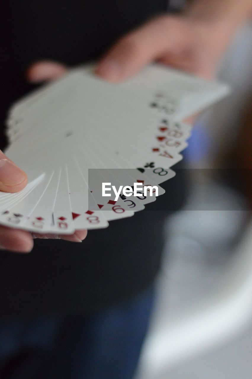 Close-up of man holding cards