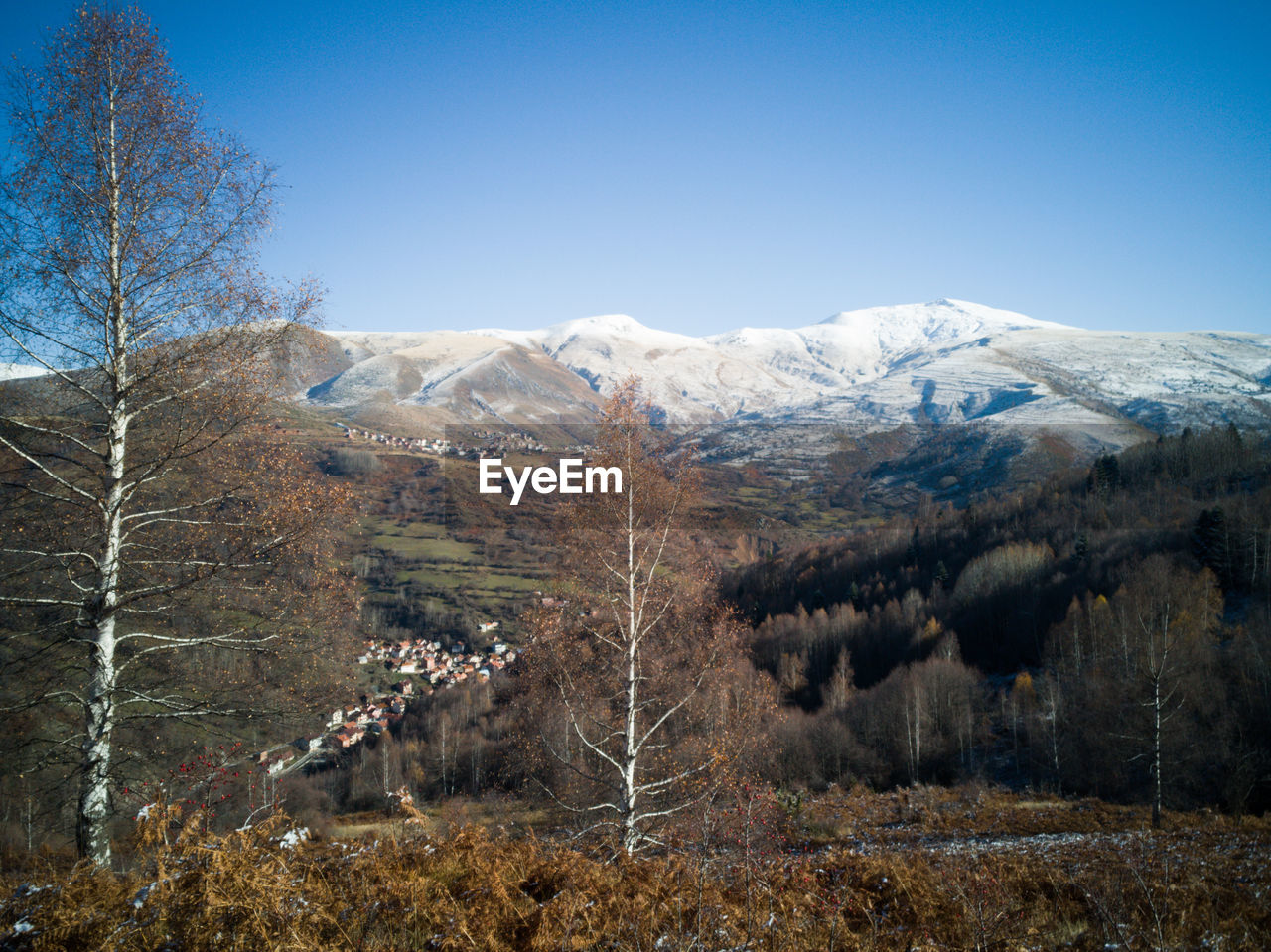 Scenic view of snowcapped mountains against clear sky