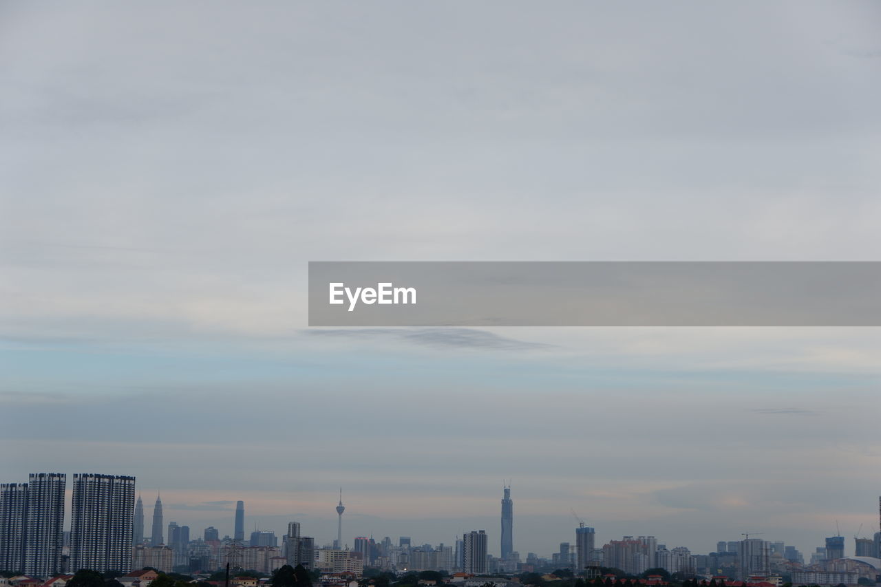 MODERN BUILDINGS AGAINST SKY AT SUNSET