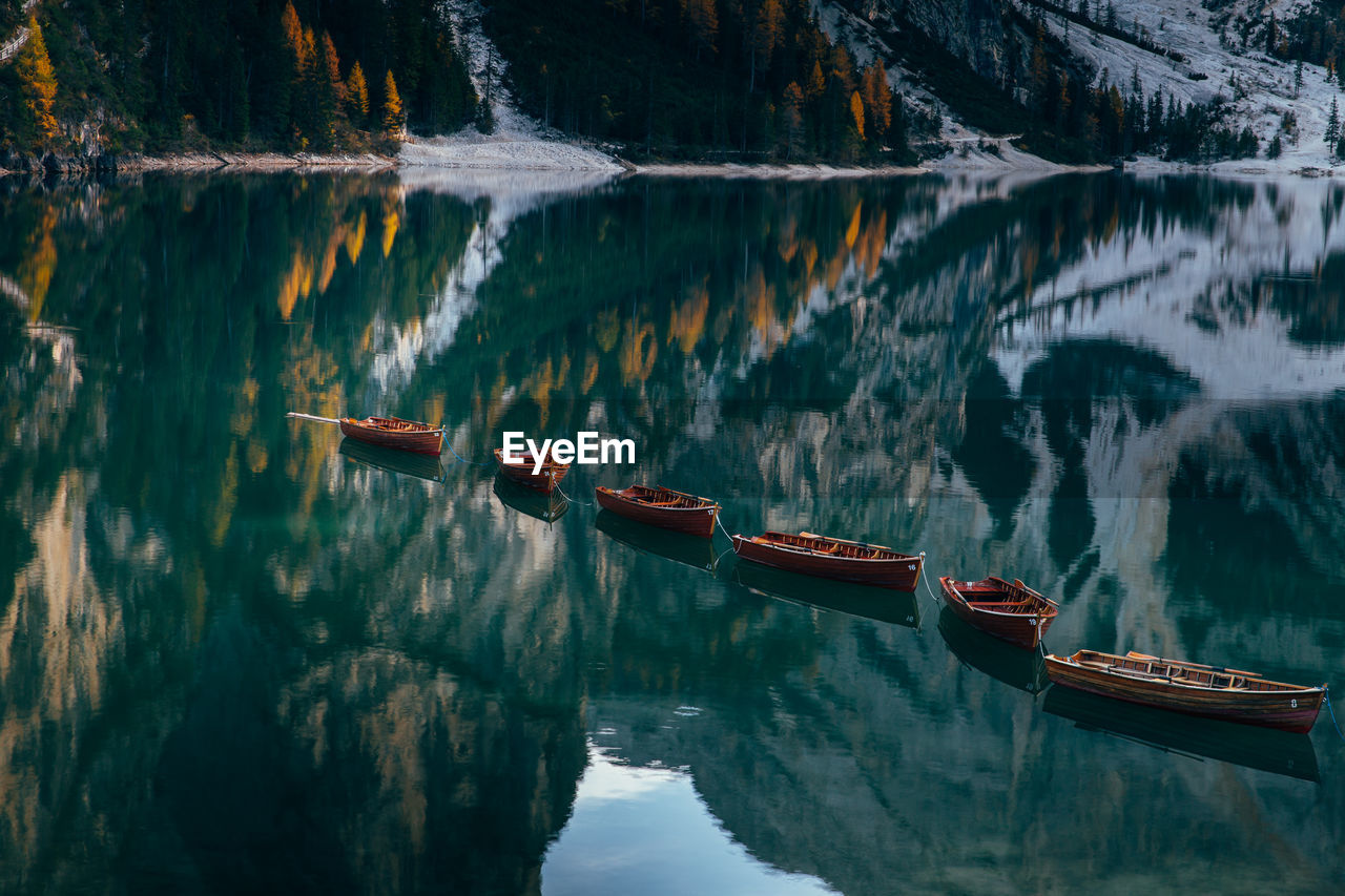 Boats in lake against mountains