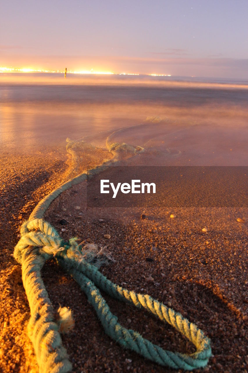 SCENIC VIEW OF BEACH DURING SUNSET