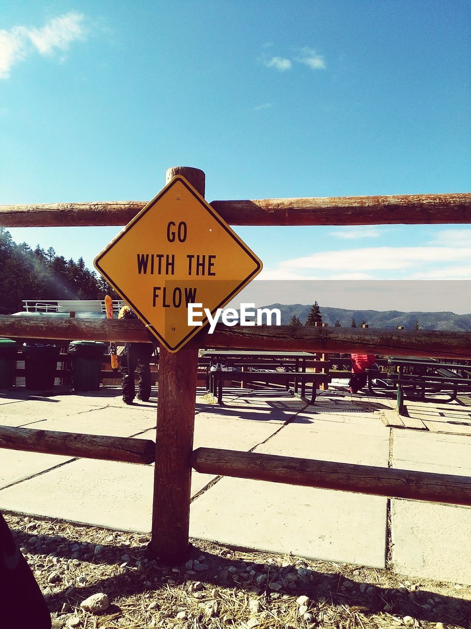 Close-up of road sign against sky