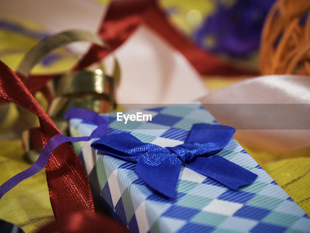 Close-up of christmas gift with blue ribbon