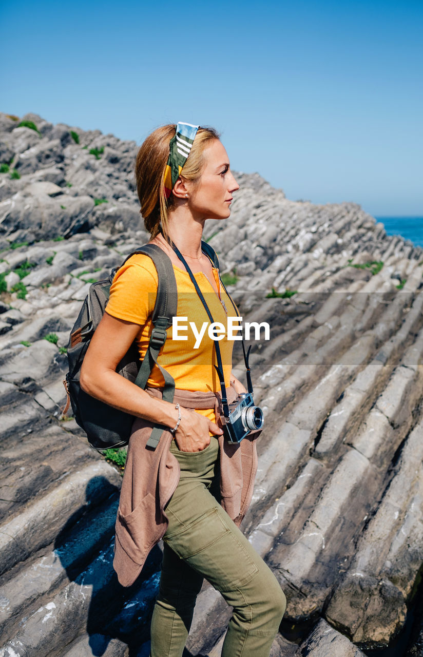 Hiking woman watching flysch rocks landscape