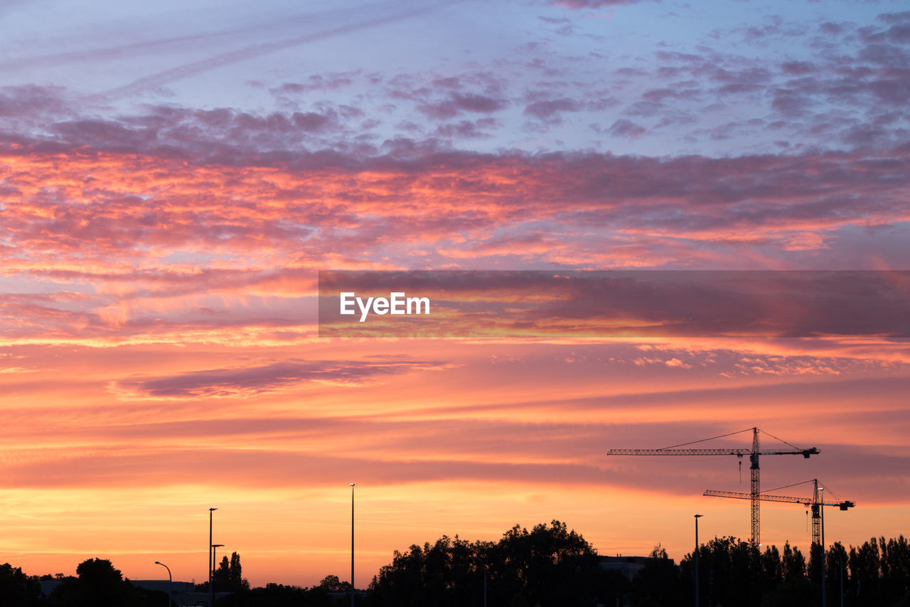 sky, sunset, afterglow, cloud, red sky at morning, orange color, silhouette, beauty in nature, nature, dawn, dramatic sky, technology, scenics - nature, horizon, environment, electricity, no people, tranquility, landscape, electricity pylon, architecture, tranquil scene, cable, outdoors, tree, idyllic, evening, plant, power generation, built structure, power line, cloudscape, power supply, sun, romantic sky, transportation, twilight