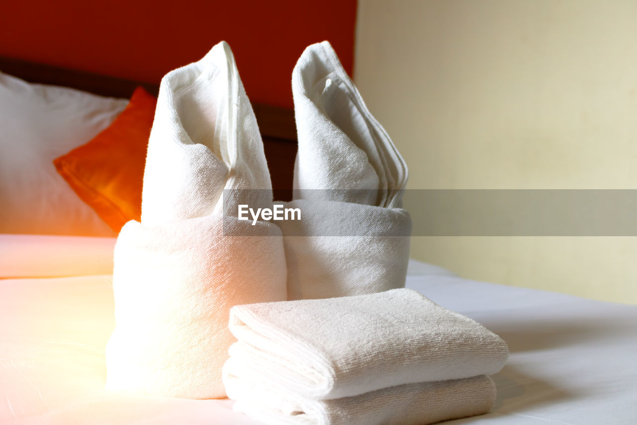 Close-up of towels on bed in hotel