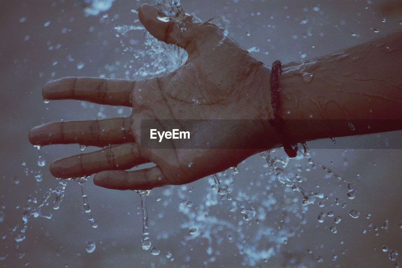 Cropped image of wet hand during monsoon