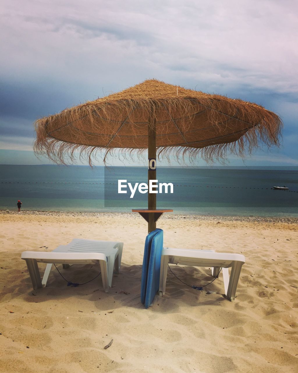 CHAIR ON BEACH AGAINST SKY