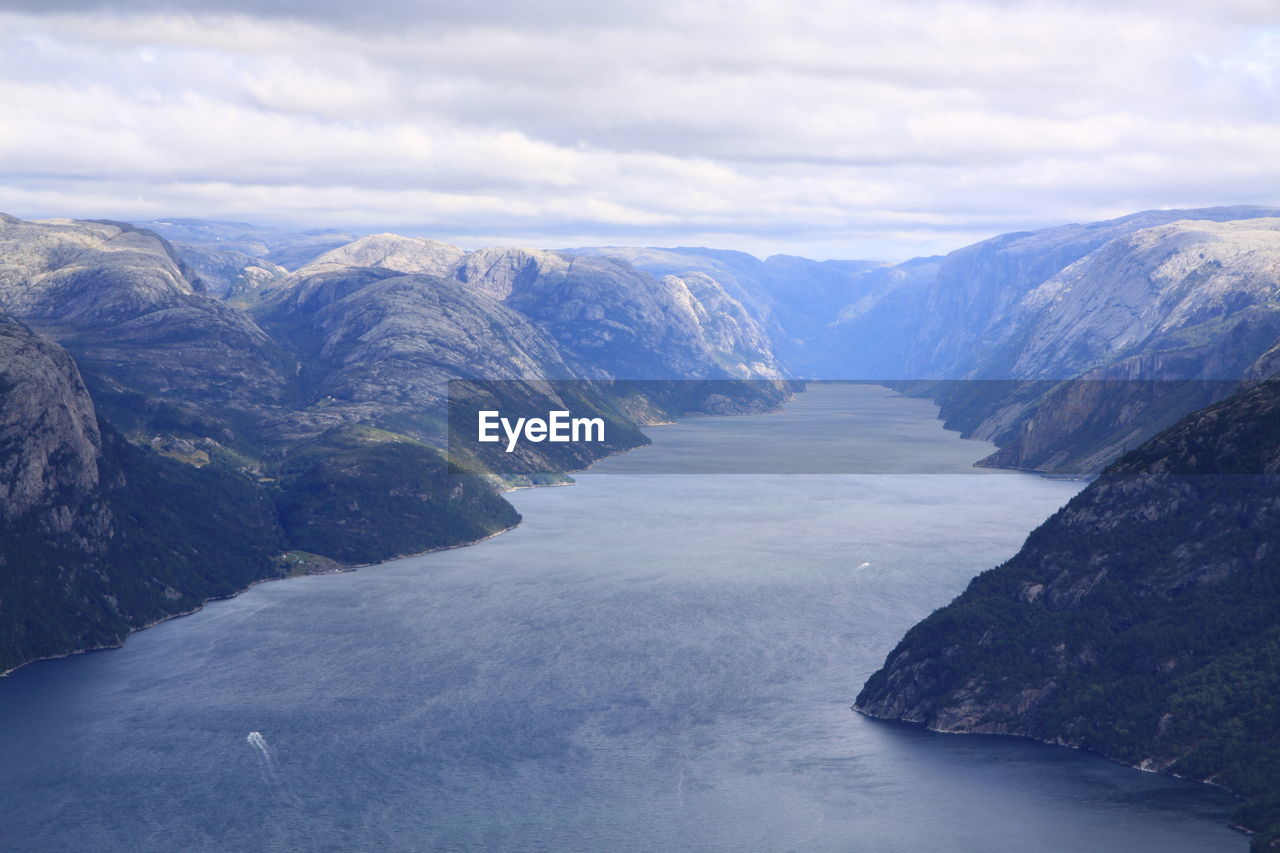 Scenic view of sea and mountains against sky