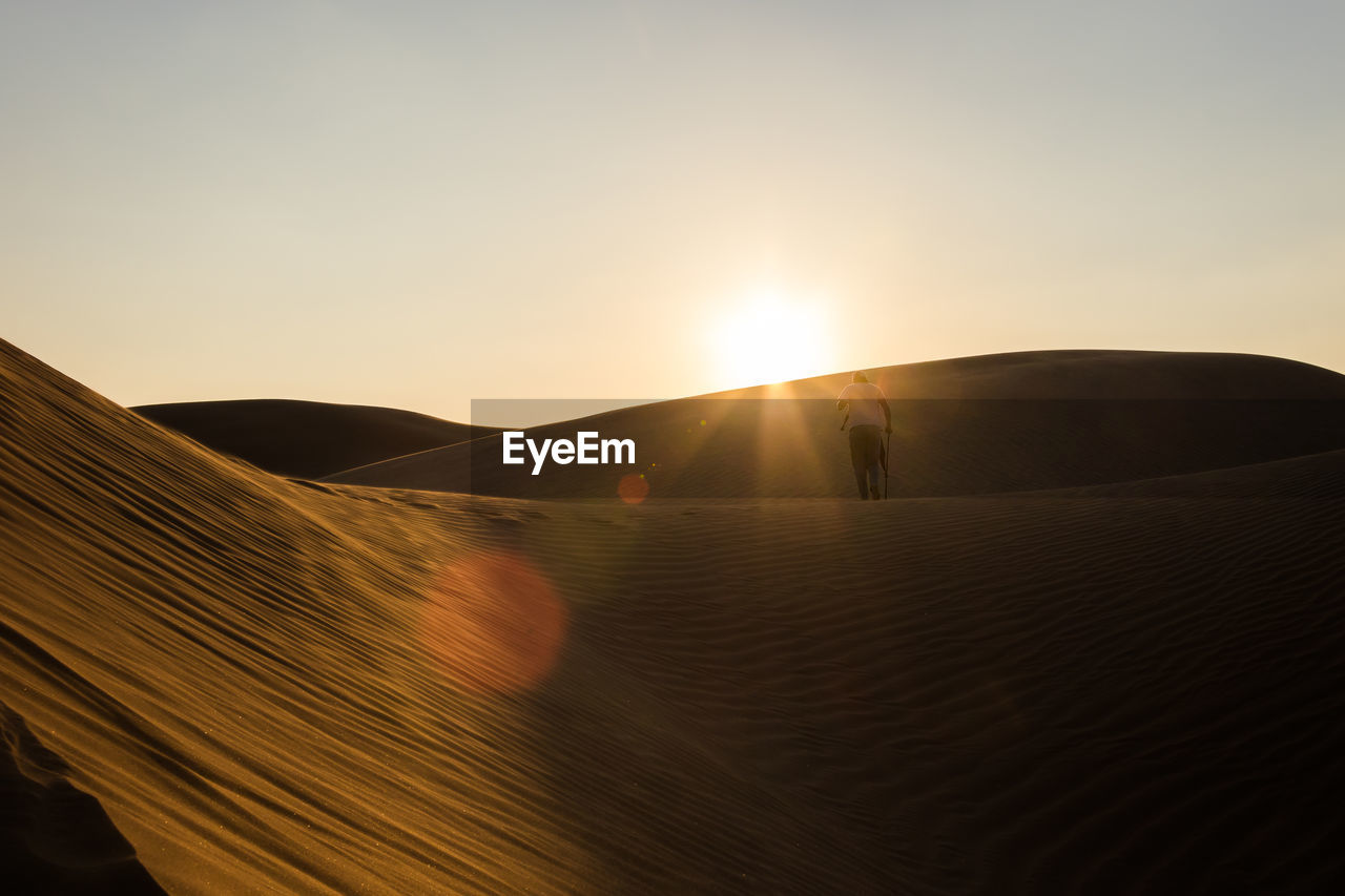 Scenic view of desert against sky during sunset