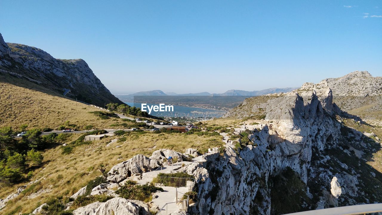 Panoramic view of landscape and mountains against clear blue sky