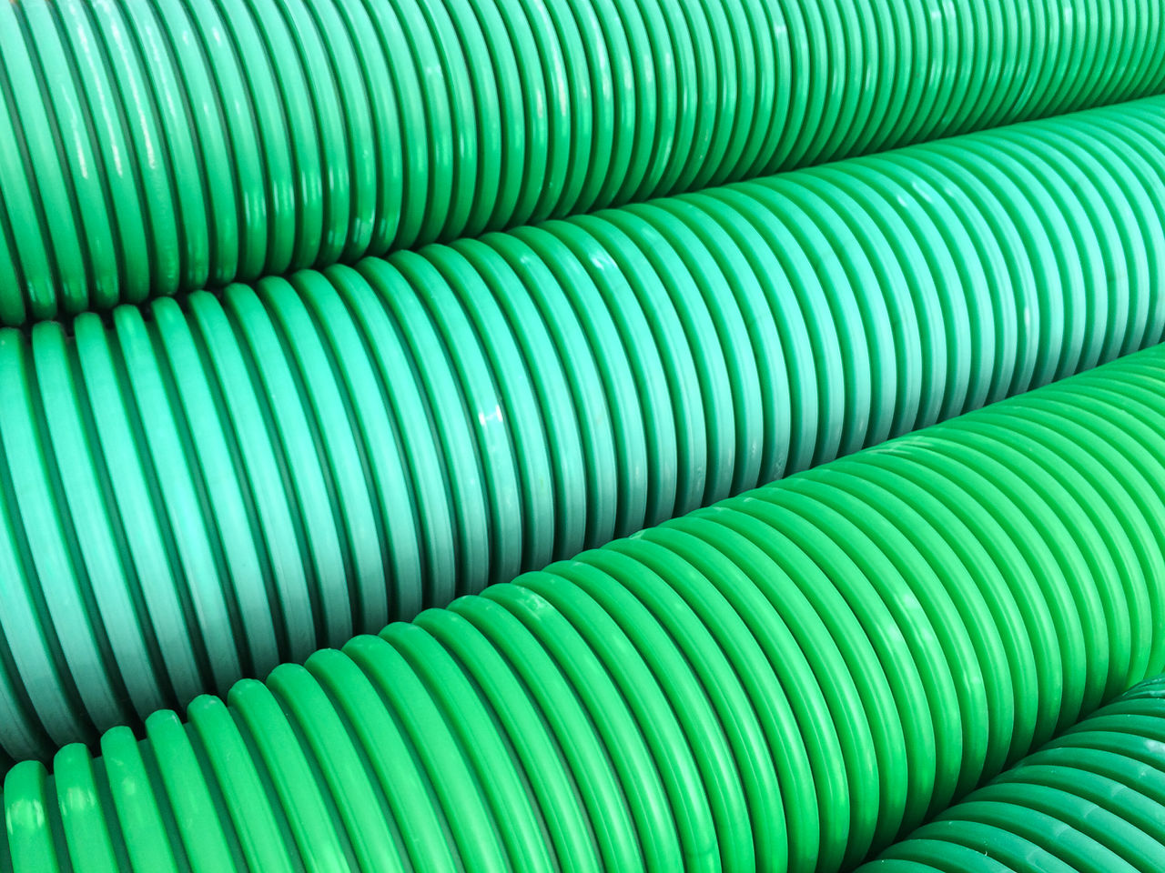 Full frame shot of green plastic pipes