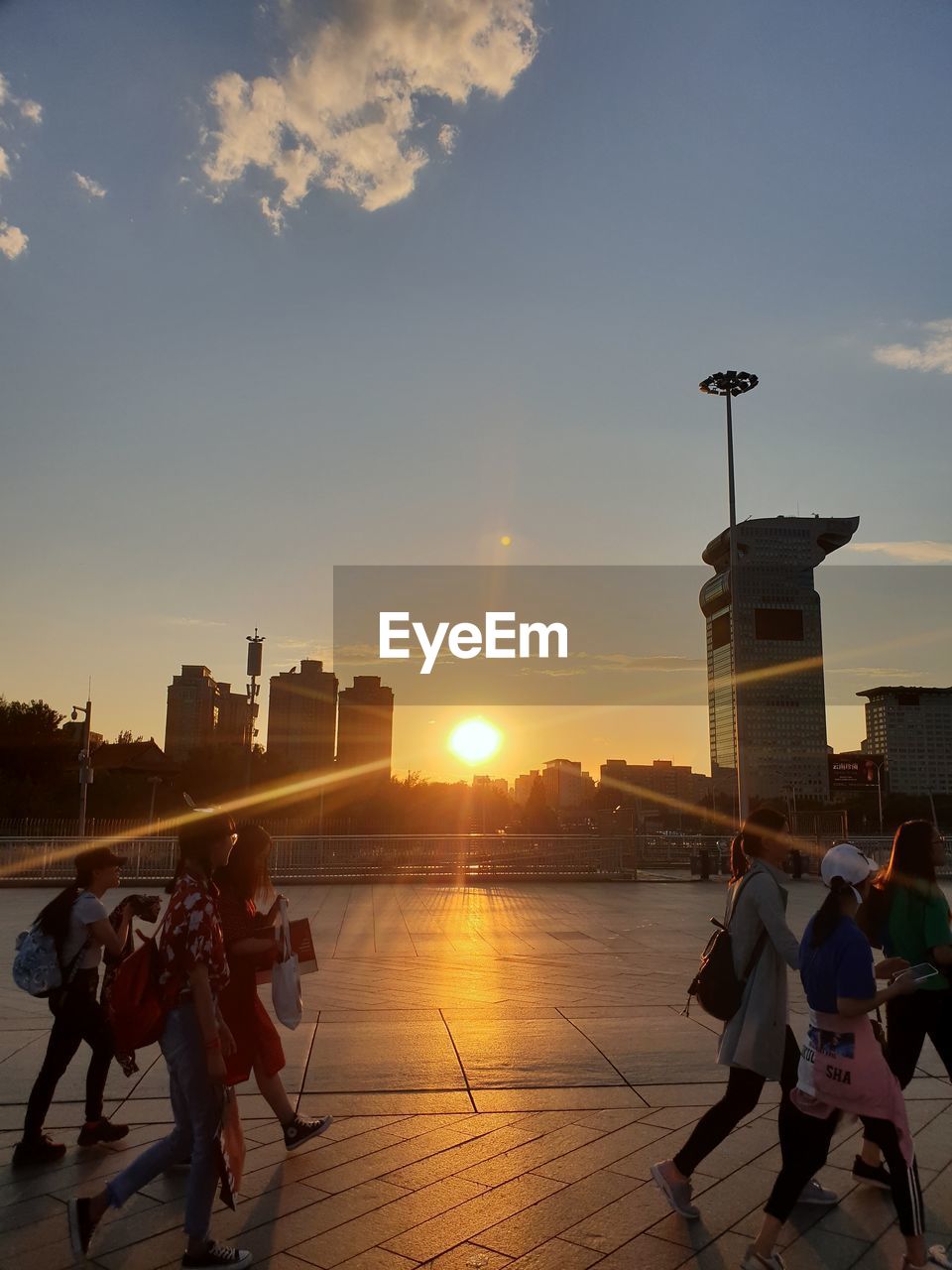 PEOPLE AT TOWN SQUARE DURING SUNSET