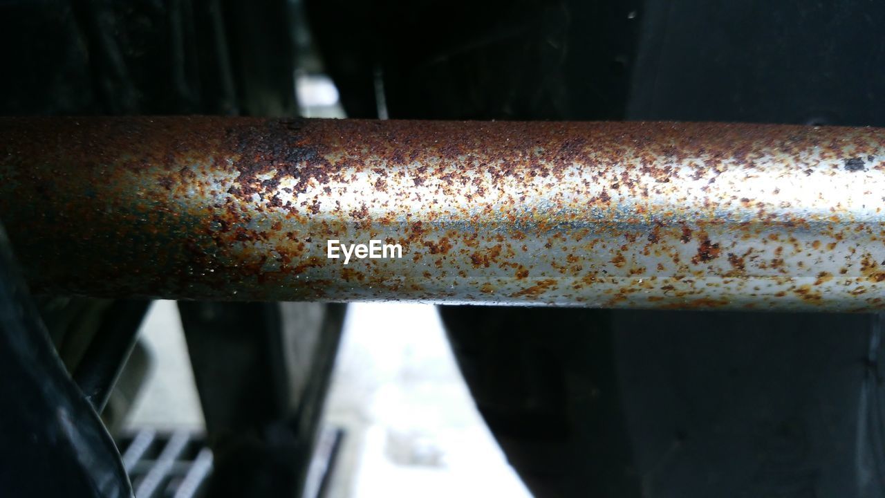 CLOSE-UP OF RUSTY PIPES