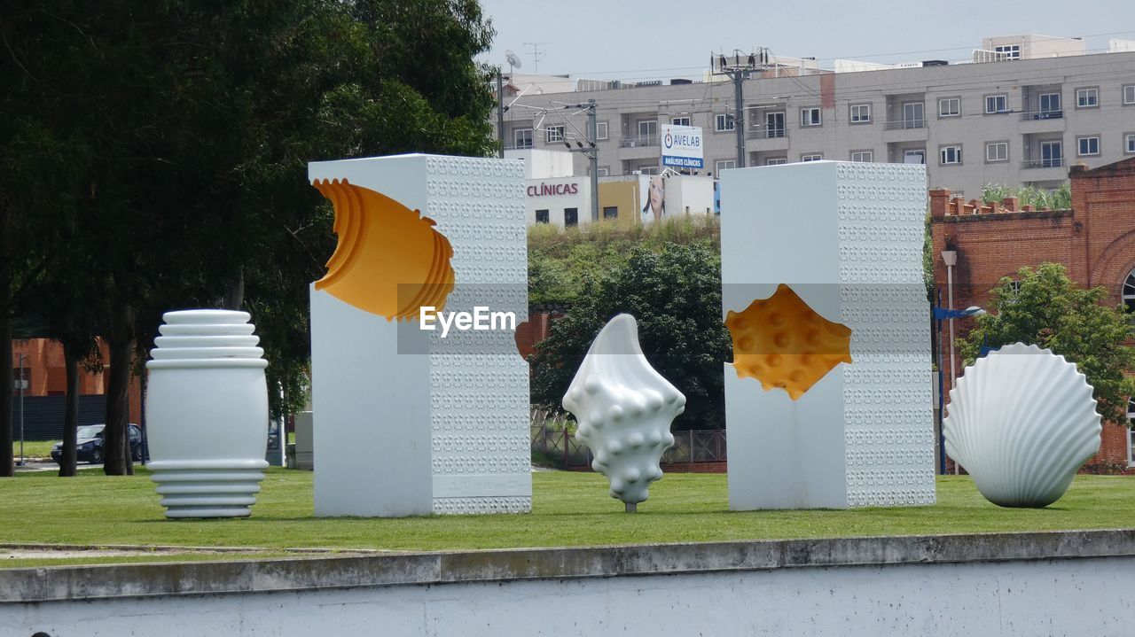 BUILDINGS IN PARK AGAINST SKY