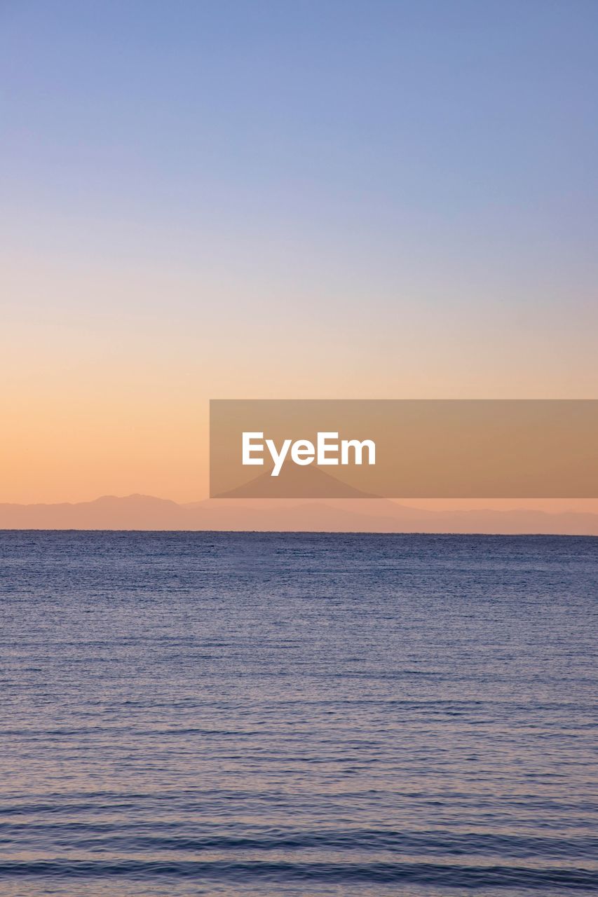 Scenic view of sea against clear sky during sunset