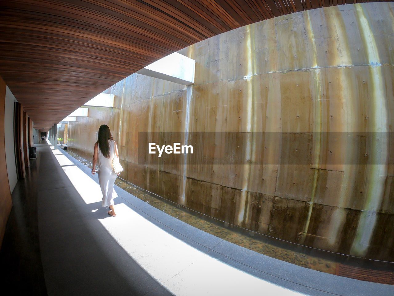 Rear view of woman walking in corridor