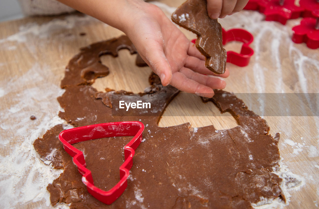 Gingerbread dough for christmas cookies and cookie cutters.