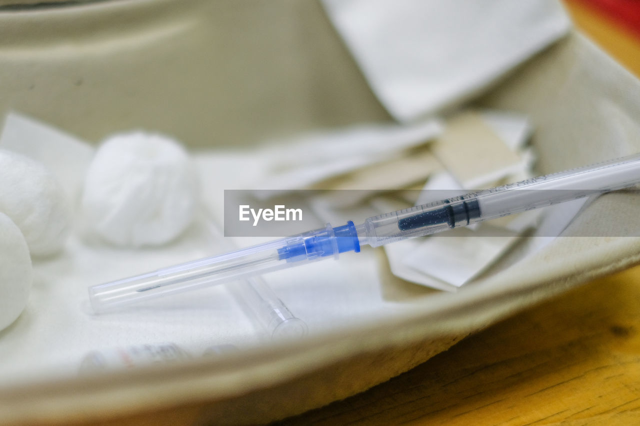 high angle view of syringe on table