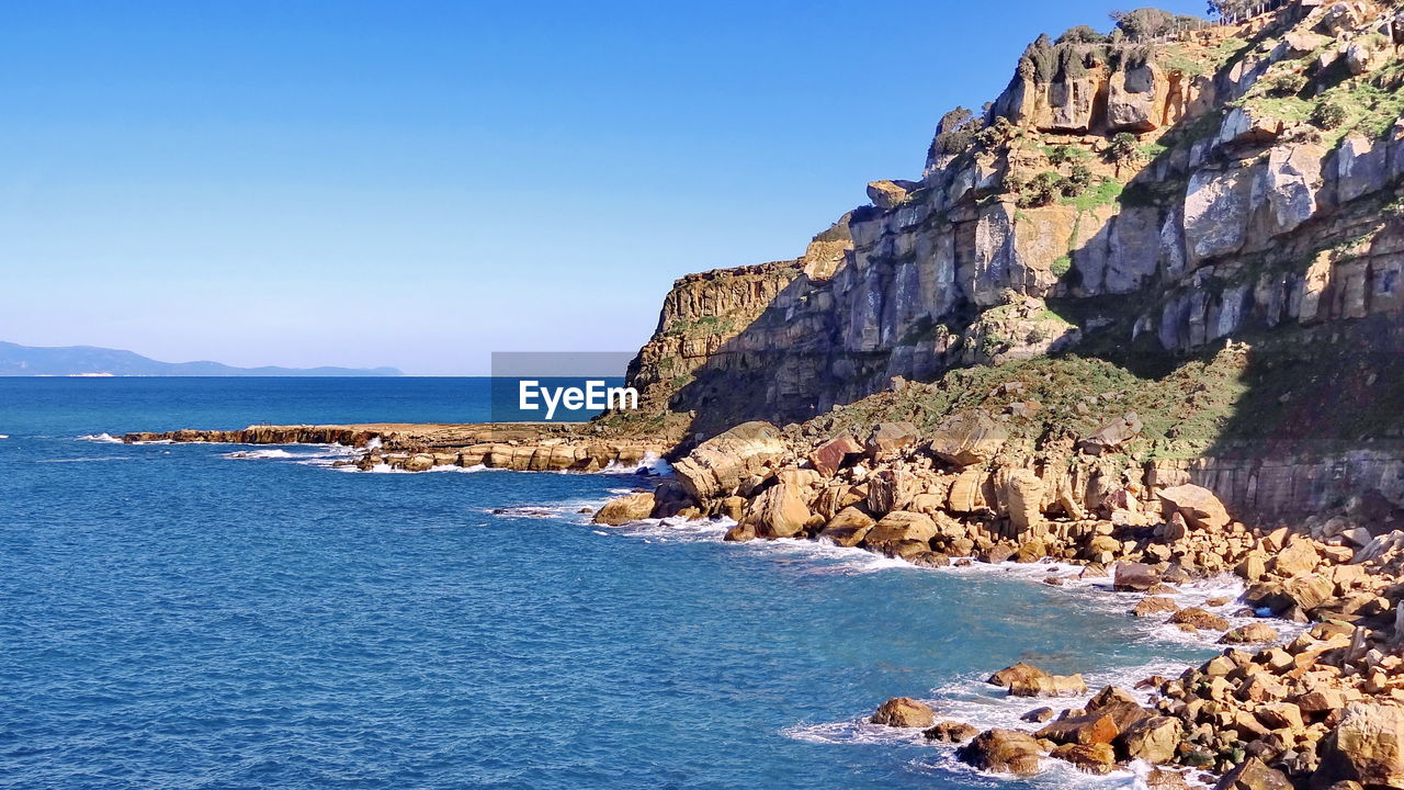 Scenic view of sea against clear blue sky