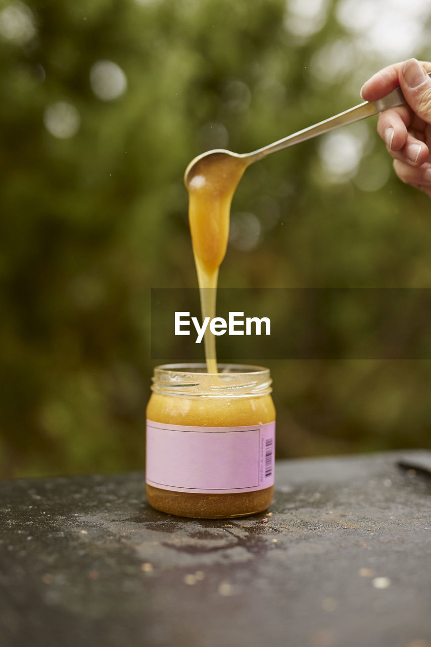 Honey being poured into jar