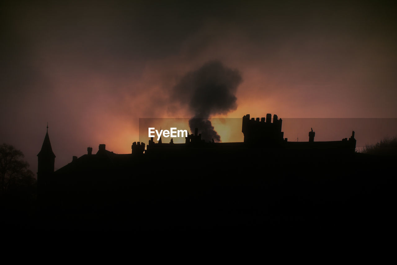 SILHOUETTE BUILDINGS AGAINST ORANGE SKY