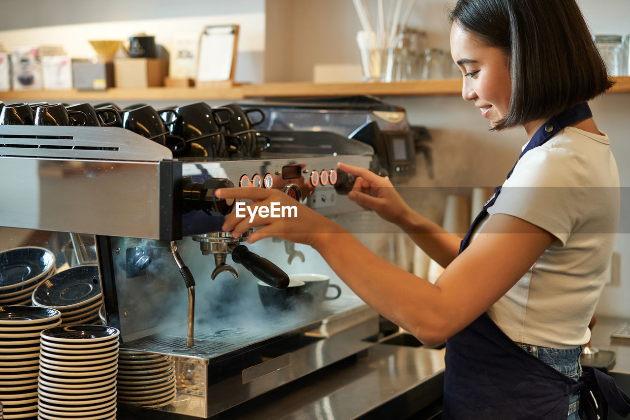 side view of young woman preparing food