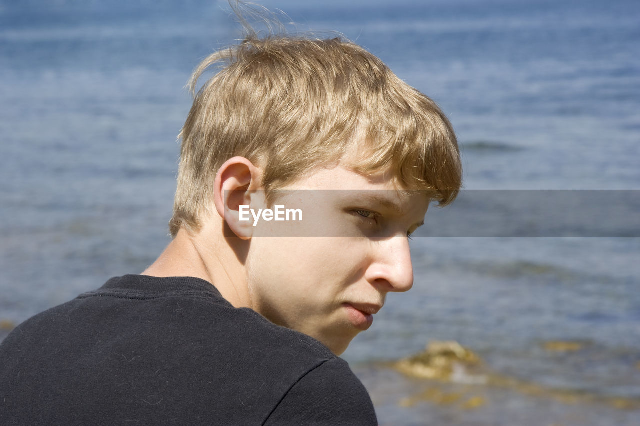 Close-up portrait of man against sky