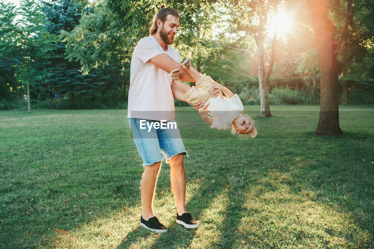 Full length of father playing with son at park