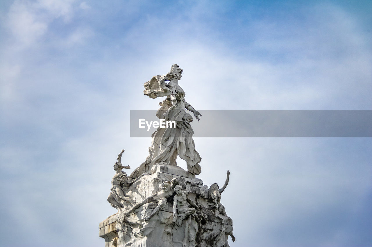 low angle view of statue against cloudy sky
