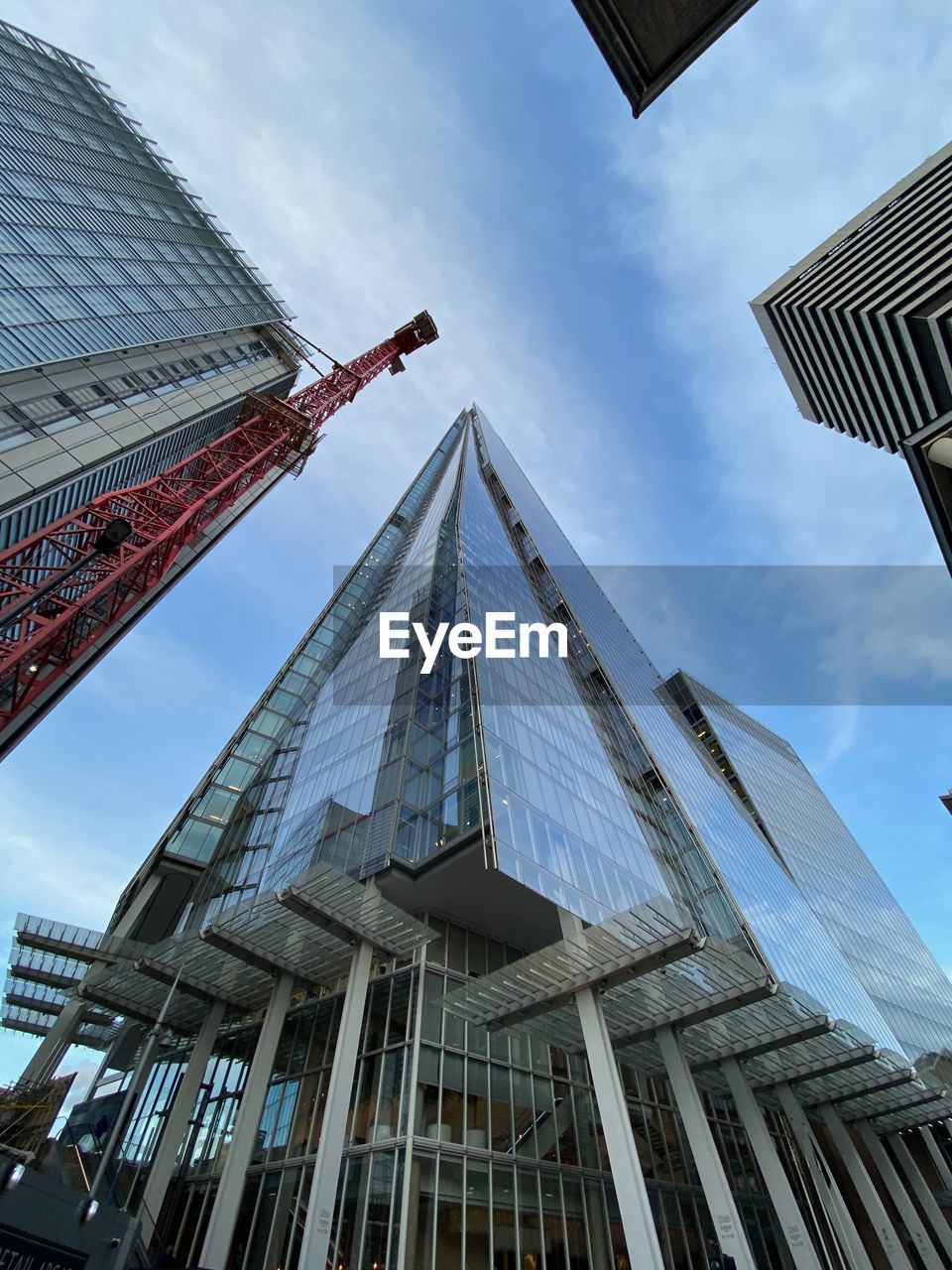 Low angle view of buildings against cloudy sky