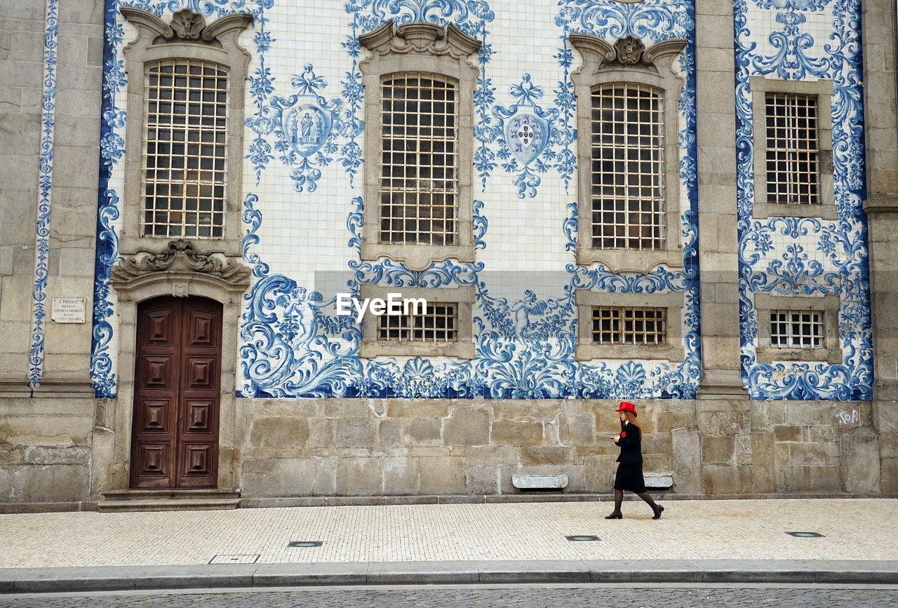 Full length of woman walking outside building