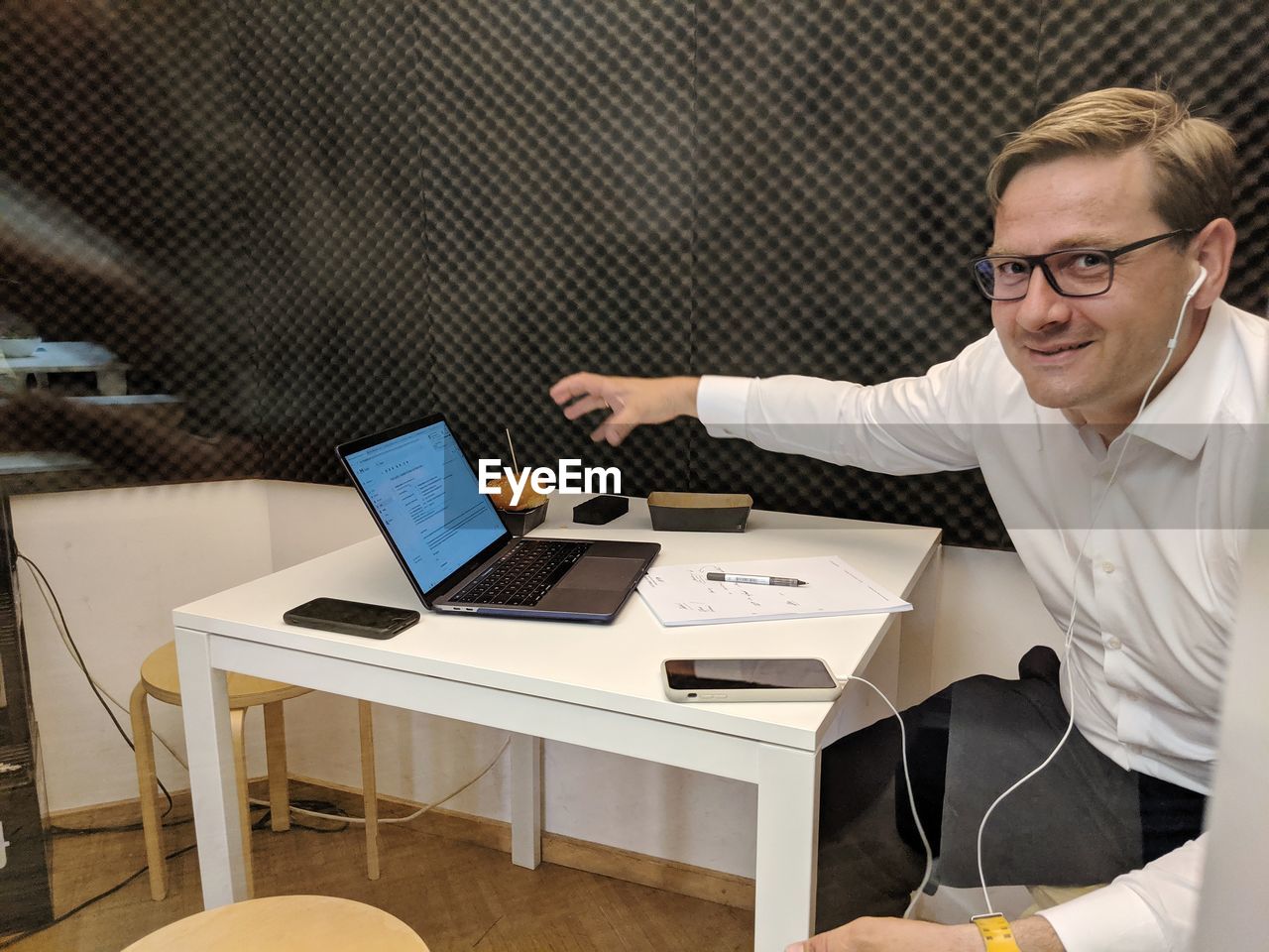 Business man multitasking through glass door