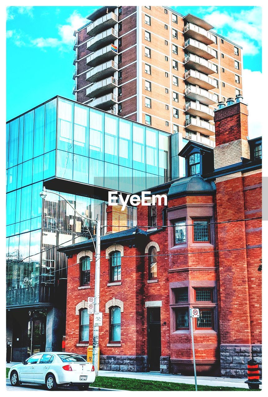 Low angle view of building by street against sky