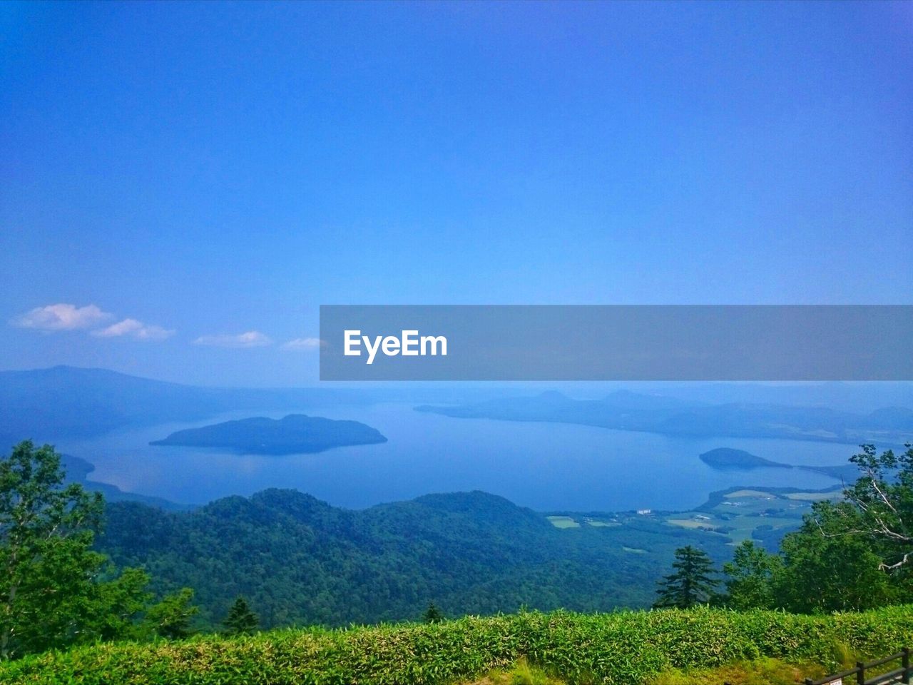 SCENIC VIEW OF GREEN LANDSCAPE AGAINST BLUE SKY