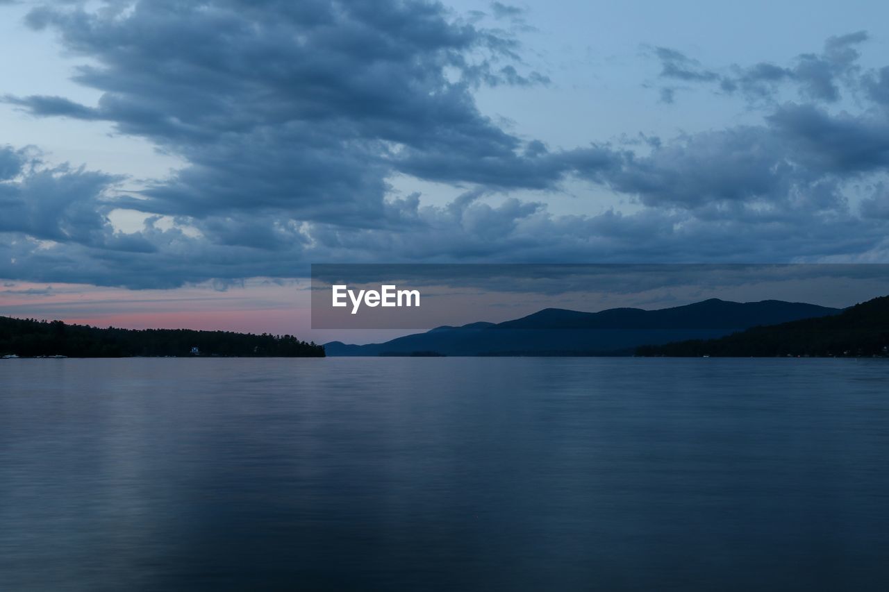 Scenic view of lake against cloudy sky