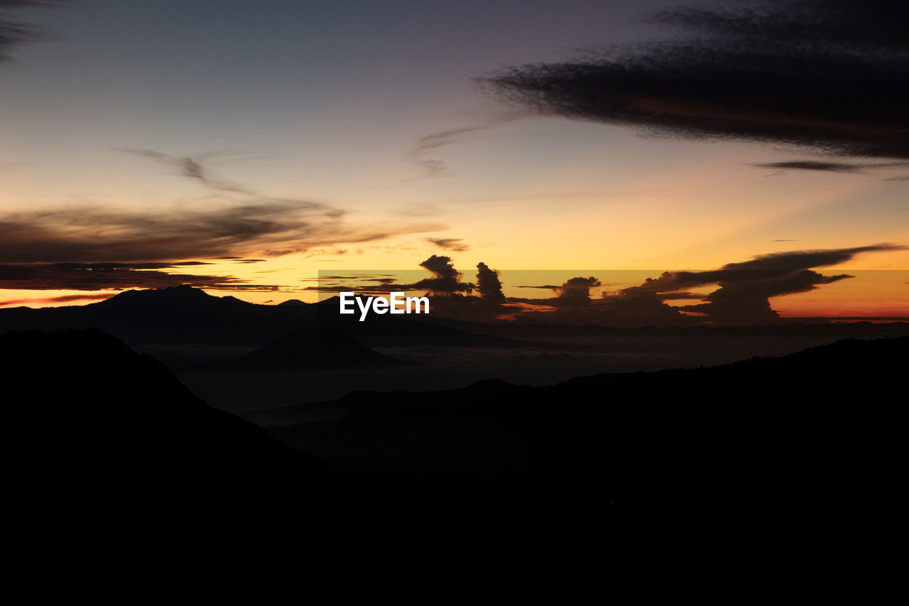 SILHOUETTE MOUNTAINS AGAINST SKY DURING SUNSET