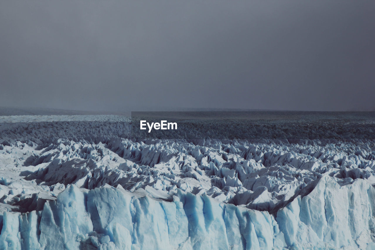 Panoramic view of snowcapped landscape against sky