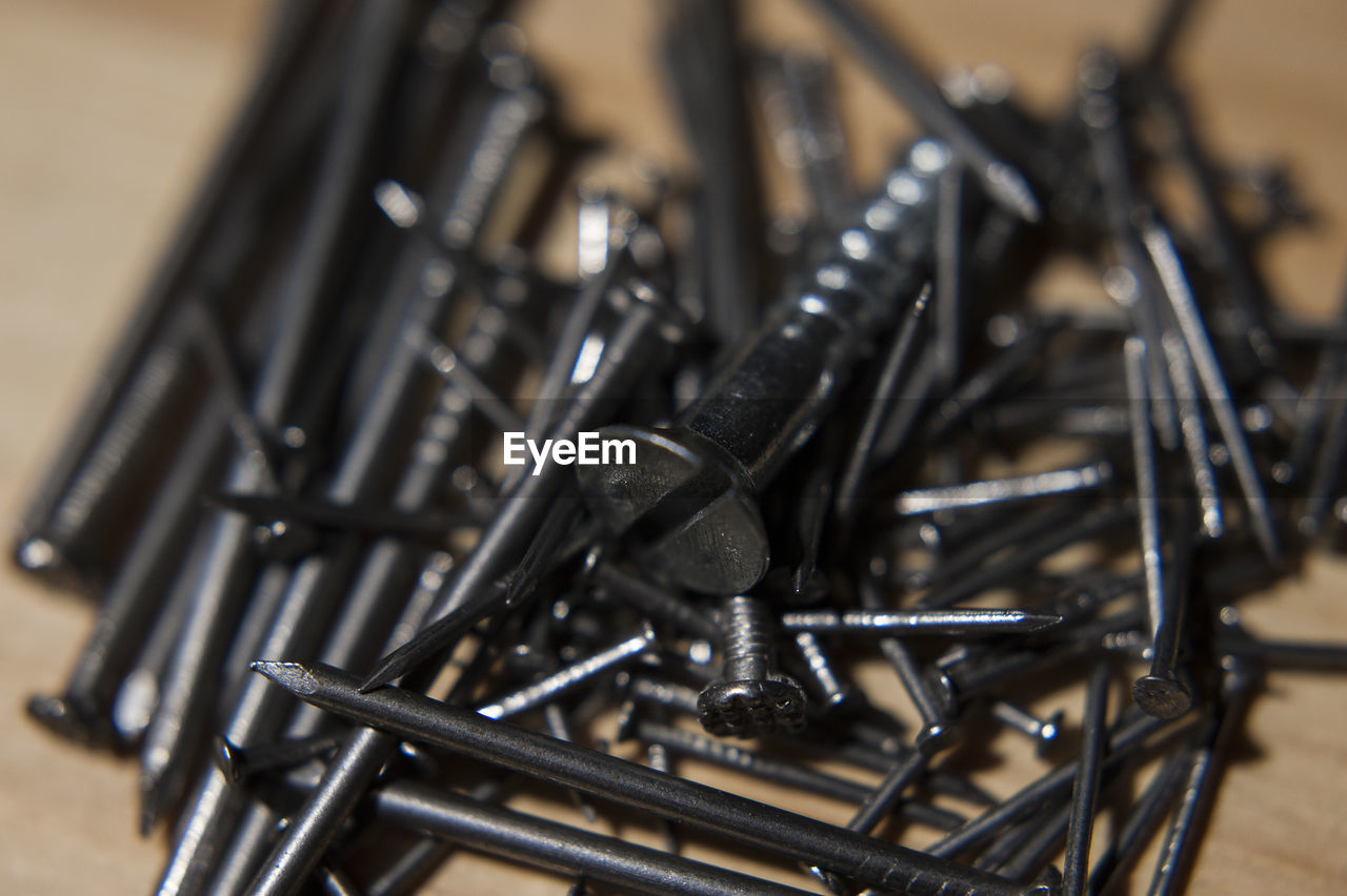 Close-up of nails on table