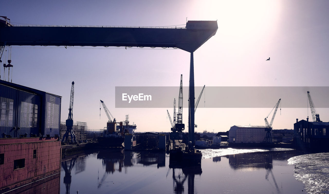 PIER AT HARBOR AGAINST SKY