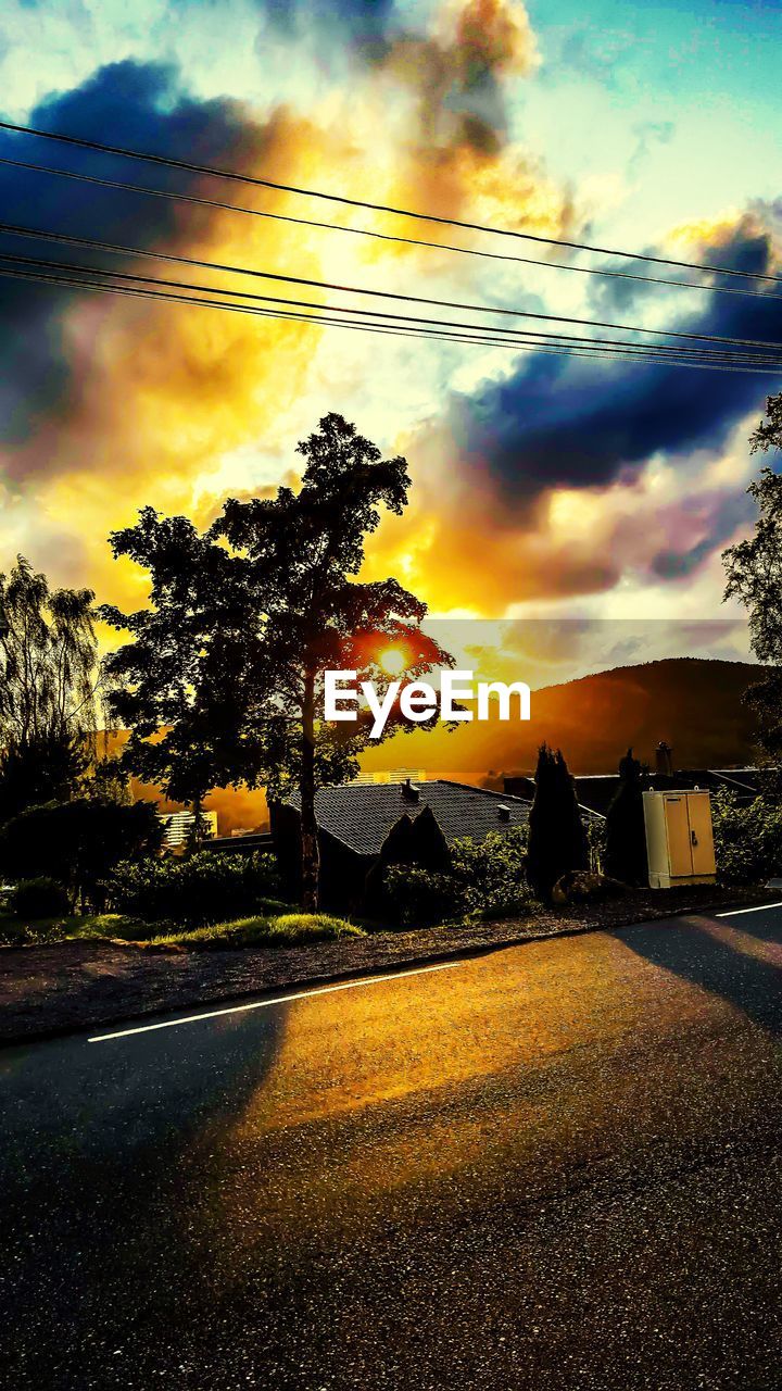 VIEW OF ROAD AGAINST CLOUDY SKY AT SUNSET