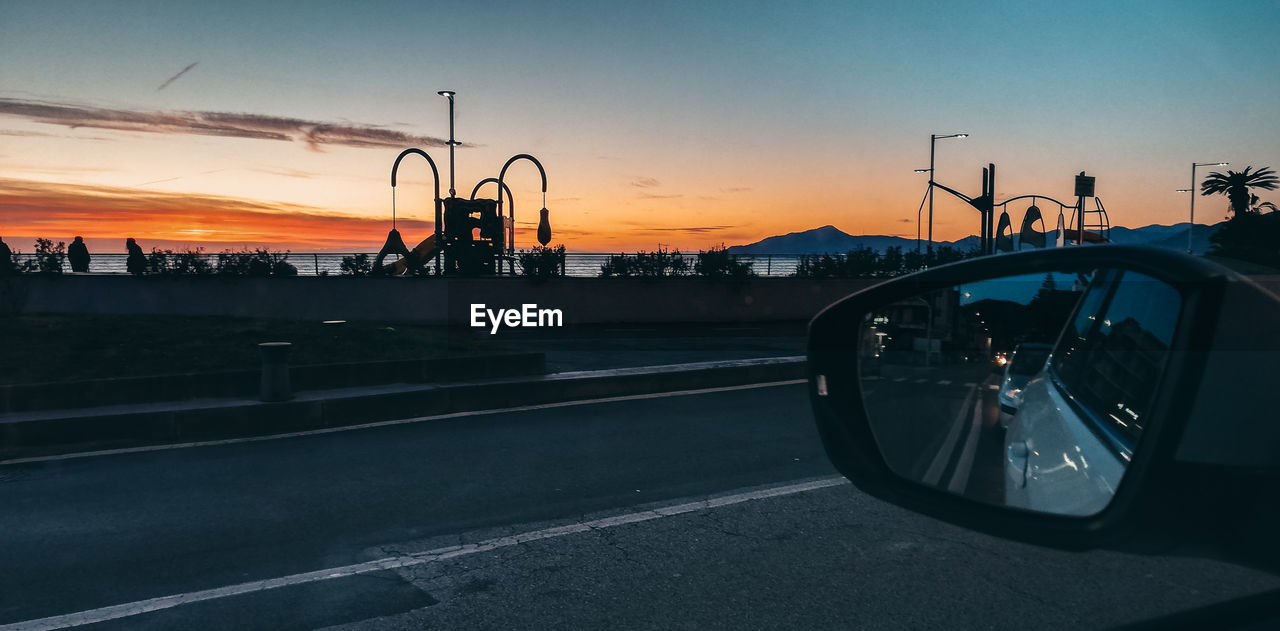 CAR ON STREET DURING SUNSET