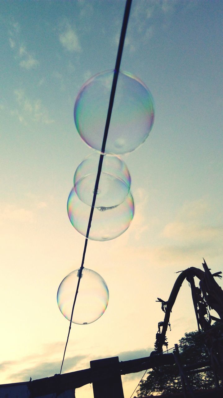 LOW ANGLE VIEW OF BUBBLES IN SKY